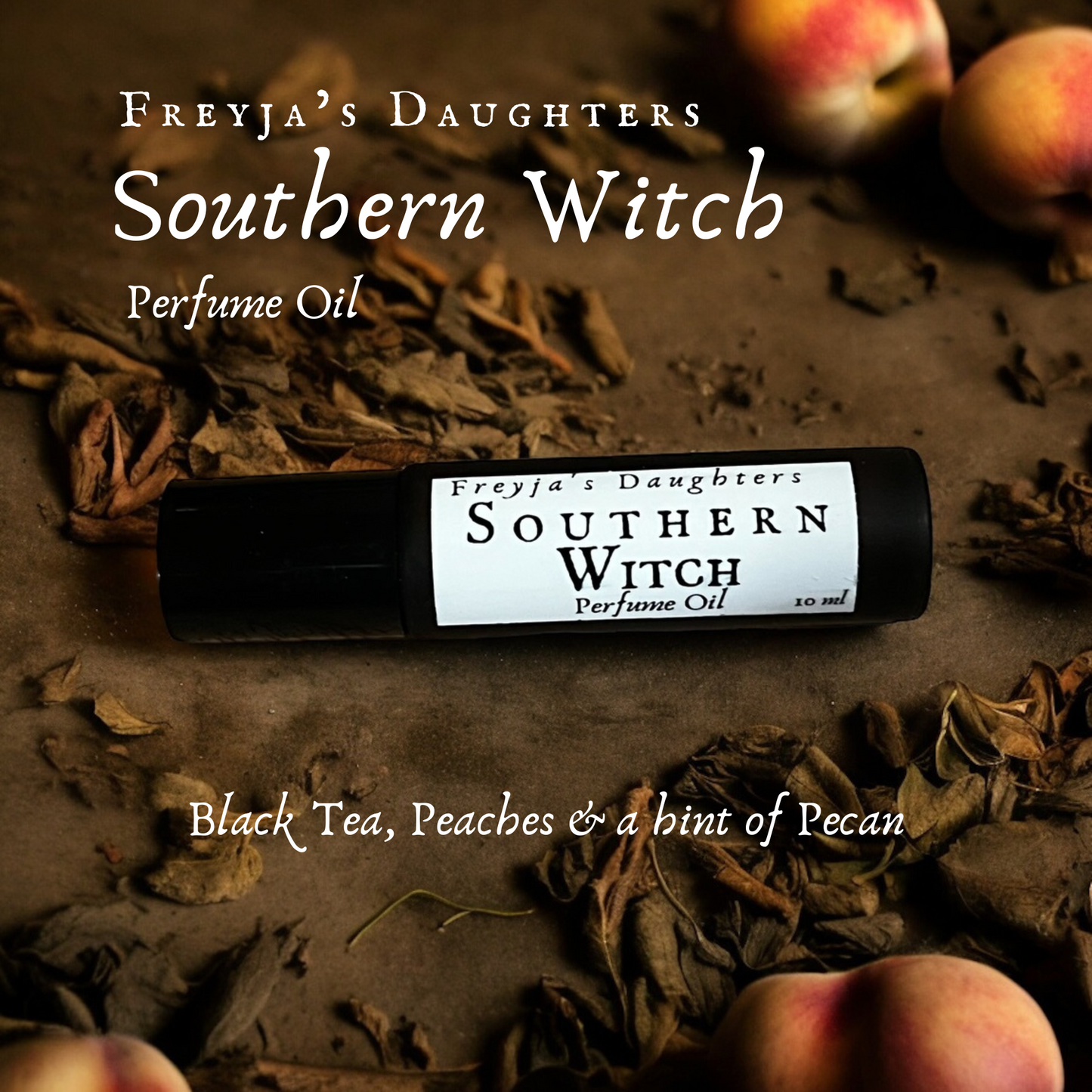 a bottle of southern witch perfume sitting on table with black tea leaves and peaches